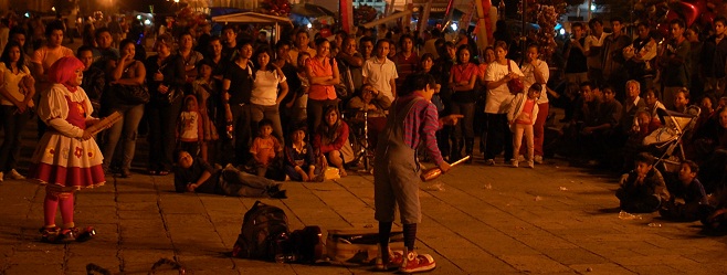 A band on stage with cheering audience